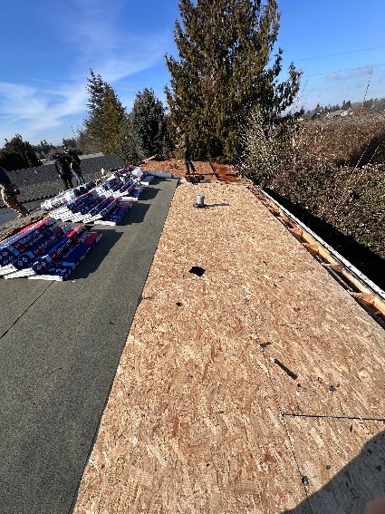 Exposed OSB deck with new underlayment and staged bundles, Portland OR